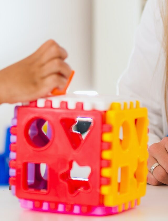 Child psychology, preschooler doing test with didactic cube